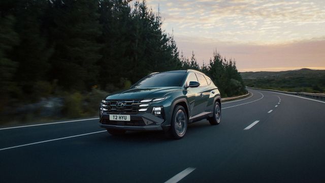TUCSON PHEV being driven on the road.