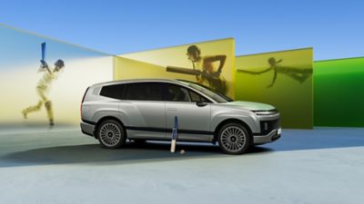 The Hyundai IONIQ 9 with a cricket bat and ball against it