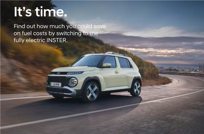 Hyundai INSTER driving on the road with front 3/4 view.