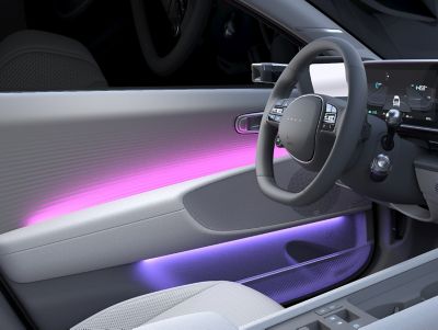 Inside view of door with ambient lighting of the Hyundai IONIQ 6 with purple light. 