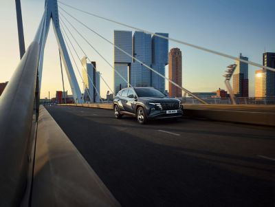 The Hyundai Tucson Hybrid compact SUV pictured on the bridge