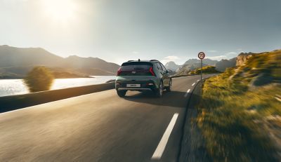 An Hyundai BAYON compact crossover SUV on the road from above.