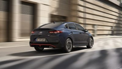 Rear view of Hyundai i30 driving on the city street.