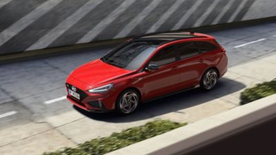 Front three-quarters view of the new Hyundai i30 Wagon N Line in red, from above.