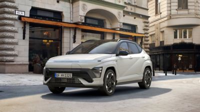 The Hyundai KONA Electric N Line parked in front of an elegant city building. 