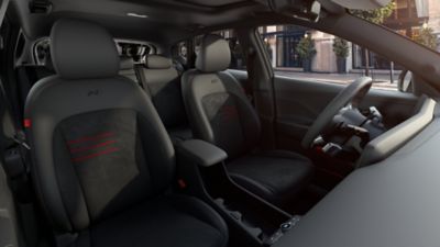 The sporty front seats of the all-new Hyundai Electric KONA N Line with red accents.