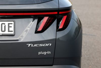 Detailfoto van badge ‘plug-in’ op achterzijde Hyundai TUSON Plug-in Hybrid.