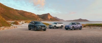 Hyundai TUCSON, SANTA FE och KONA vid havet med berg i bakgrunden. 