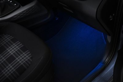  Tartan fabric seats and ambient lighting in blue inside the Hyundai i10. 