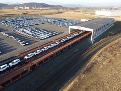 Hyundai cars are loaded on a train for delivery.