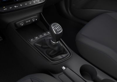 A manual transmission gear lever inside the Hyundai BAYON compact crossover SUV.