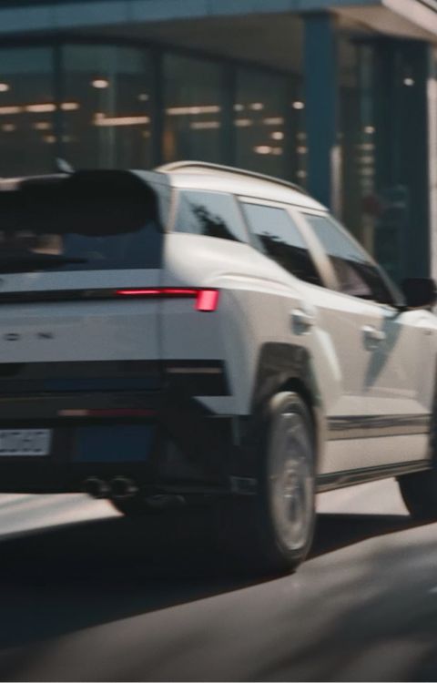Rear view of Hyundai BAYON N Line driving on the city street.