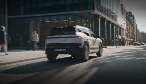 A rear view of Hyundai BAYON N Line driving down the city street.