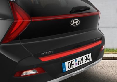 Hyundai BAYON Rear bumper trim line accessory in tomato red.