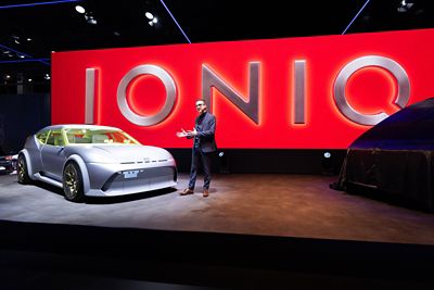 A person presenting the Hyundai Concept THREE concept car on an auto show stage
