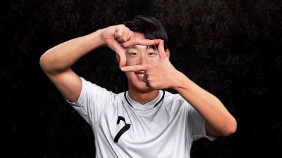 Son Heung-Min forming a hand gesture while wearing a jersey with number 7