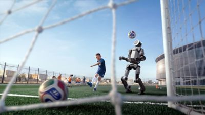 Hyundai Boston Dynamics humanoid robot Atlas playing football with a boy.