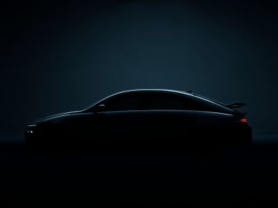 Side view of a Hyundai IONIQ 6 N with a sleek silhouette and illuminated rear lights.