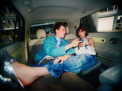 A man and a woman sitting in the roomy back seat of the new Hyundai INSTER electric car.