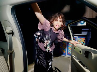 The Hyundai INSTER interior shot with women looking into the car.