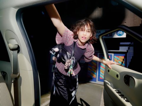 A woman looking into the open driver's door of the new Hyundai INSTER.