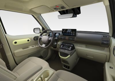 Dashboard Hyundai INSTER met zicht op stuurwiel, 10,25-inch digitaal instrumentenpaneel en 10,25-inch infotainment-touchscreen.