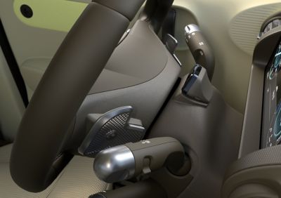 Closeup of the steering wheel mounted paddle shifters on the new Hyundai INSTER small electric car.