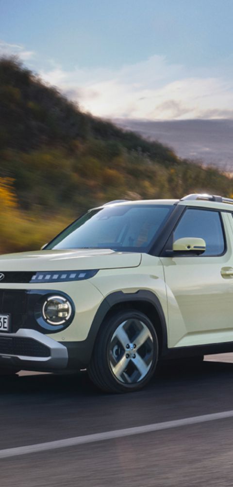 Hyundai INSTER on a scenic road with Euro NCAP rating overlay.