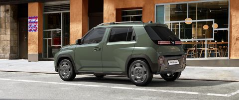 The rear view of the Hyundai INSTER Cross parked on a city street.