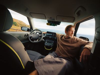 Hyundai INSTER Cross trim interior with man sat inside looking out.