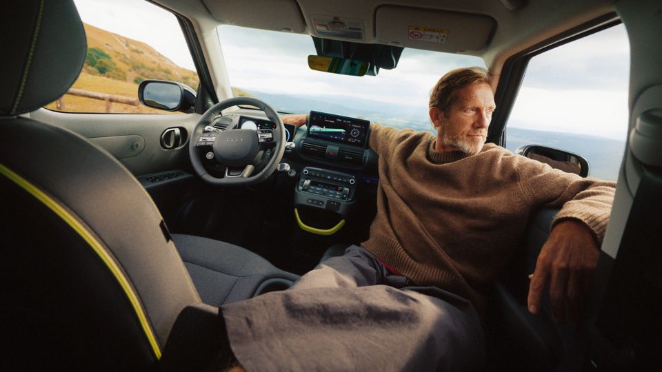 Passengers inside a Hyundai vehicle interacting during a journey.