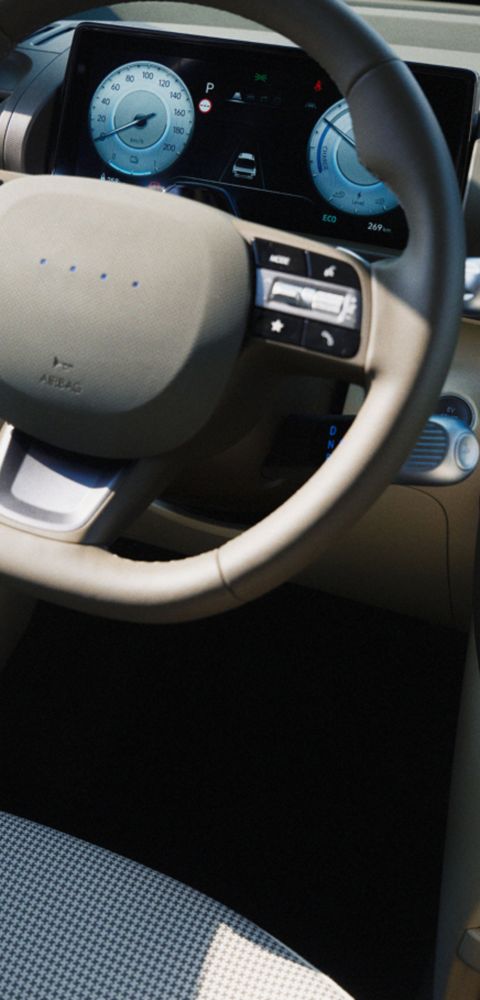 Interior view of front seat and steering wheel, centre touchscreen of the Hyundai INSTER.