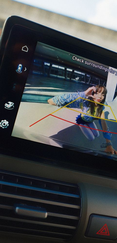 Rear view monitor of the Hyundai INSTER small electric car with a woman pictured on the screen.