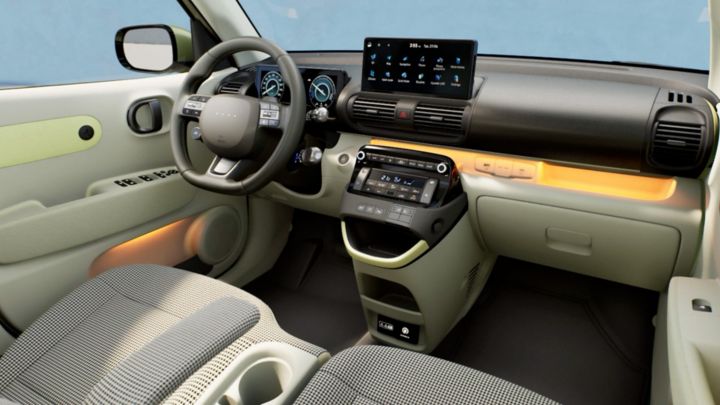 The cockpit, front seats and steering wheel inside the Hyundai INSTER small electric car.