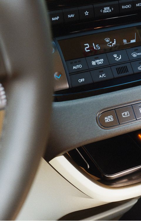 Wireless charging port and climate controls located in the centre console of the Hyundai INSTER.