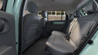 Rear seats of the Hyundai INSTER Lounge decorated with supple leather and fabric upholstery.