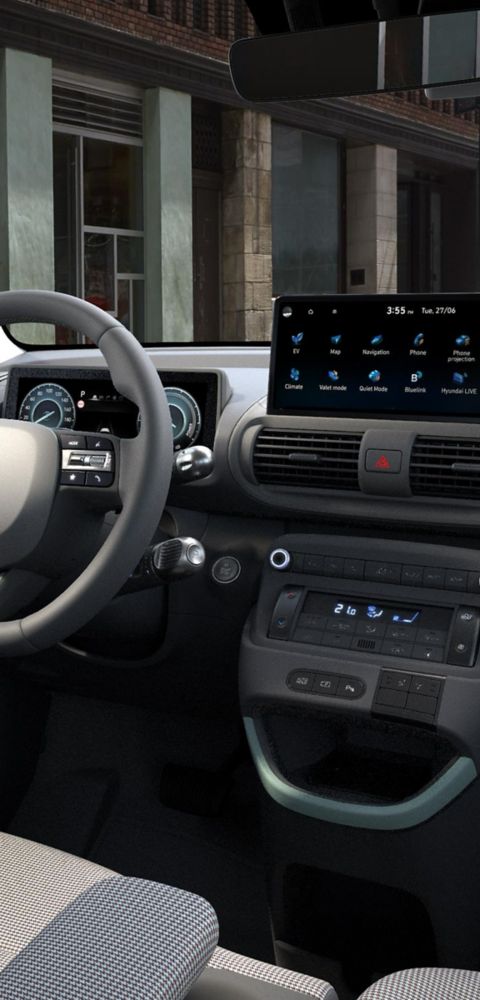 A man reclining on the folded down front seat of the new Hyundai INSTER Cross.