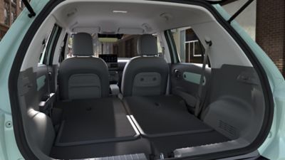 View through the open hatchback of Hyundai INSTER Lounge rear seats folded flat.
