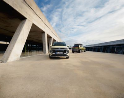 The new Hyundai INSTER and INSTER cross small electric car parked on top of the parking garage.