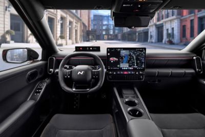 The N Line steering wheel, center display inside the black Hyundai IONIQ 3 N Line interior.