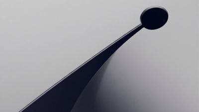 Abstract composition with a curved stripe rising toward a circular shape.