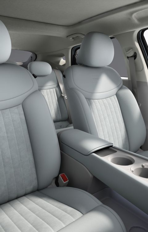 The two front seats in grey inside the Hyundai IONIQ 3.