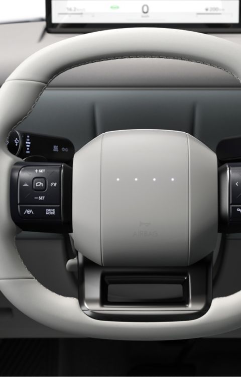 LED steering wheel and center touch screen inside the Hyundai IONIQ 3.
