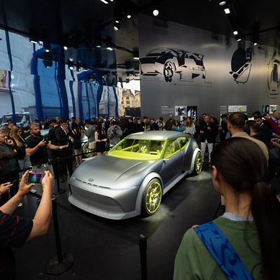 Crowd viewing the Hyundai Concept THREE concept car displayed at an auto show booth