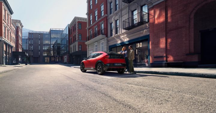 Hyundai IONIQ 3 parked on the road, rear view with people opening the boot.