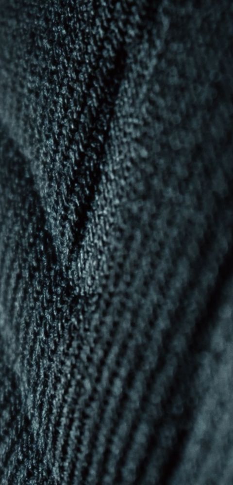 Hyundai IONIQ 3 interior fabric and stitching close-up in dark blue and black tones.