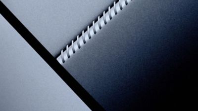 Abstract close-up of layered surfaces with a spiral-like structure between them.