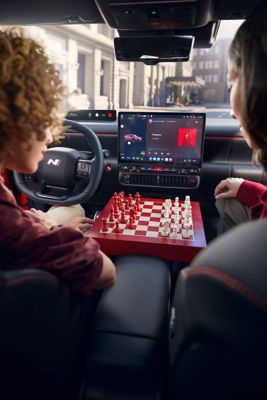 Hyundai IONIQ 3 interior centre console with a wooden chessboard between the front seats.