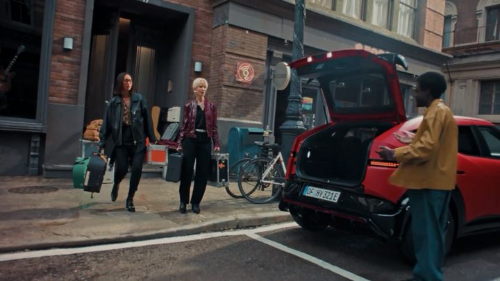 Image of a band packing musical instruments into a red Hyundai IONIQ 3 N Line.