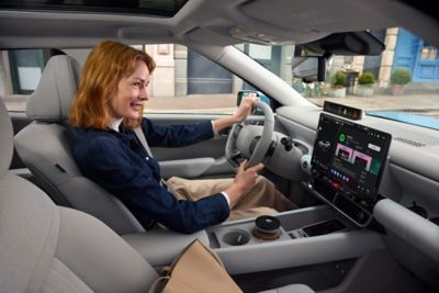 Woman in the driver's seat inside the Hyundai IONIQ 3.